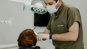 Dentist carrying out dental treatment following a botched dental procedure