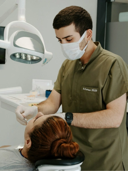 Dental surgery compensation – dentist treating a patient during a cosmetic dental procedure